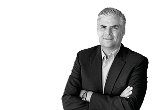 CEO Stefan Kratochwill smiles with his arms folded