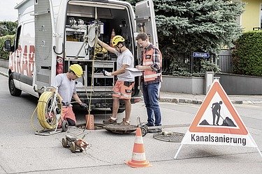 Photo of construction workers renovating a sewer