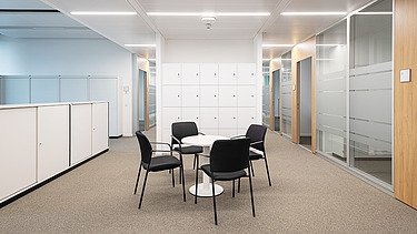 Interior of the Esslingen District Office with conference table and cupboards, equipped with resource-saving materials