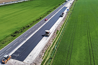 Concrete road renovation with sand Bird's-eye view of a highway road rehabilitation project