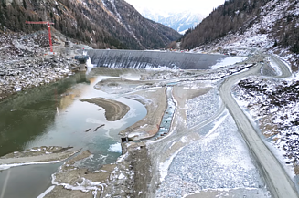 Drone footage of a large-scale construction site in the high mountains, featuring a video on the construction of a pumped-storage power station
